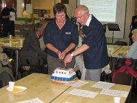 Rose and Ron, cutting the 20th celebration cake.