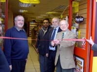 Ron proudly cutting the ribbon